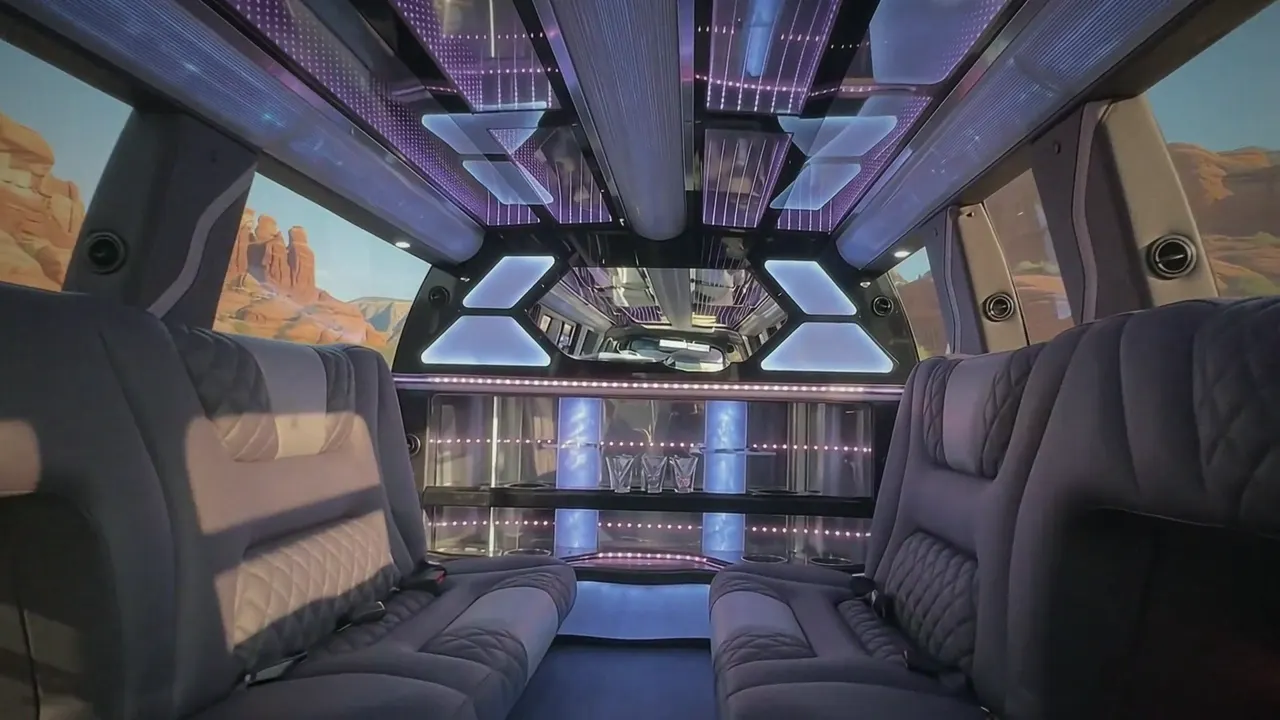 Inside the Cadillac Escalade limo in Thornton Colorado: LED light-show ceiling, leather lounge seating and lit bar